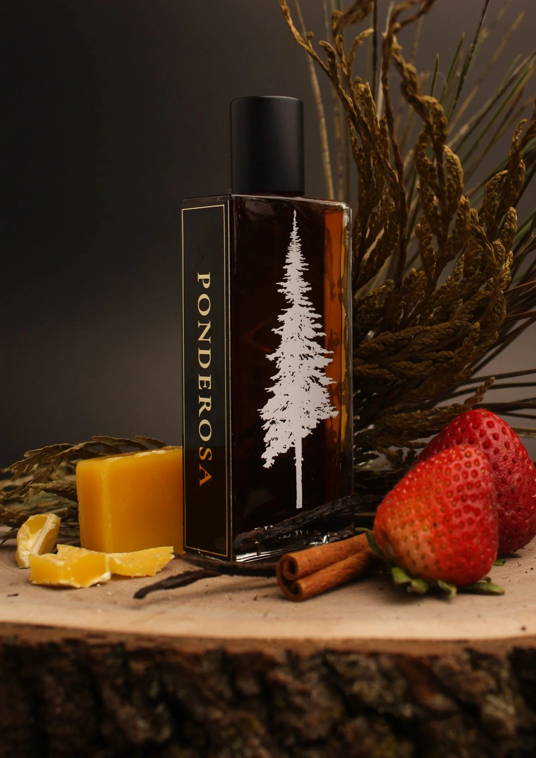 Fragrance bottle with black cap and vertical PONDEROSA label, white pine tree graphic