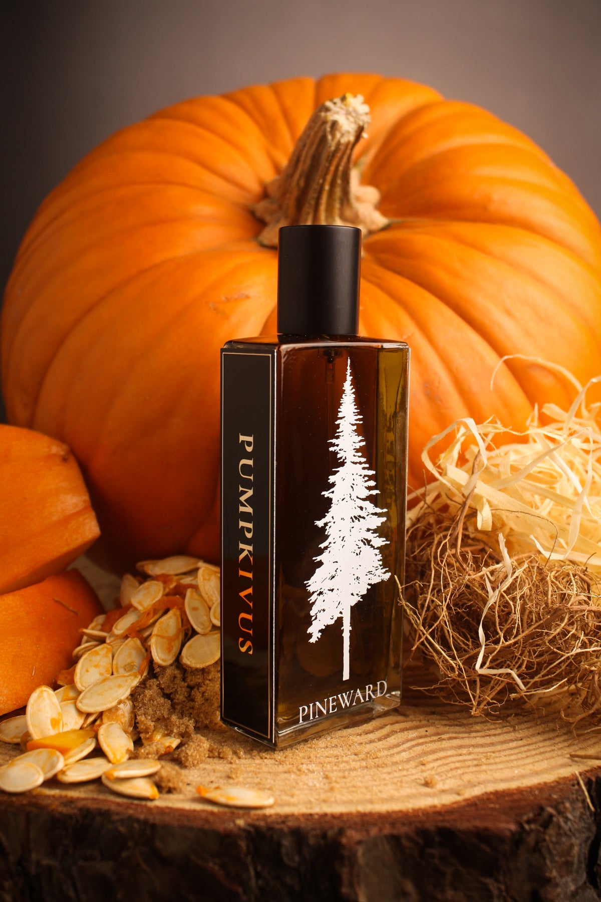 Perfume bottle and box set in dark amber with black cap, white pine tree label
